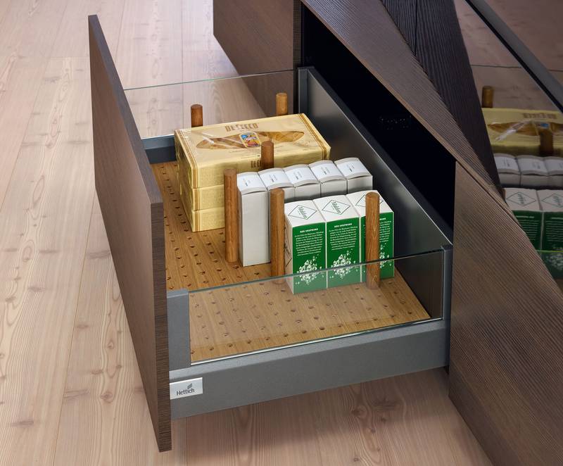 The versatile OrgaStore organisation system in oiled oak keeps everything neat and tidy while holding objects securely in place. Photo: Hettich